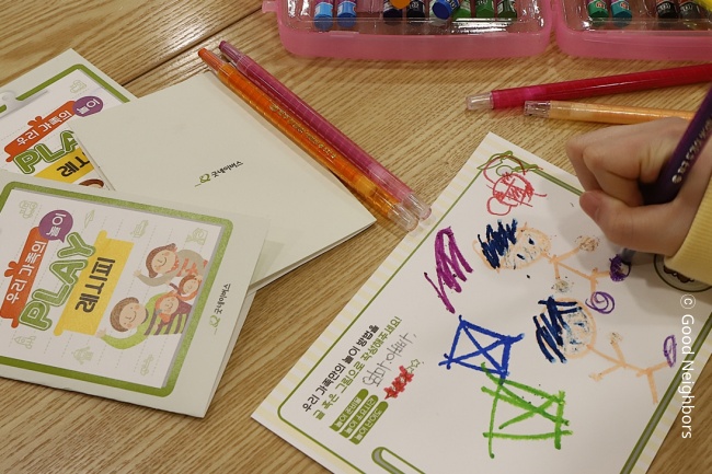 아동이 '우리 가족의 놀이 레시피'를 그리고 있는 모습 