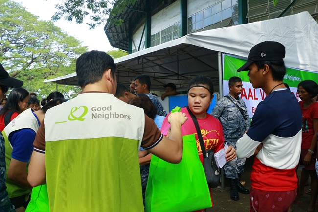 필리핀 지역 주민에게 구호 물자를 전달하고 있는 모습