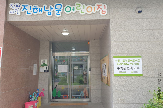 창원시립 진해남문어린이집 입구에 달린 ‘굿네이버스 수익금 전액 기부’ 현판 모습